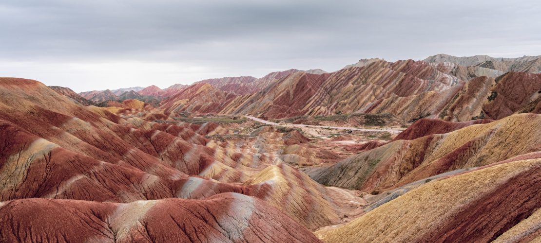 An amazing scenery of colored mountains under a cloudy sky